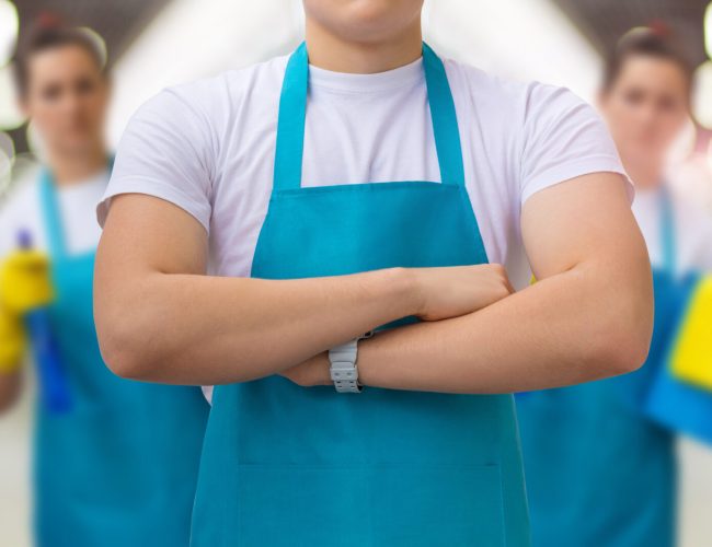 Group of cleaners standing on blurred background. Concept cleaning service.