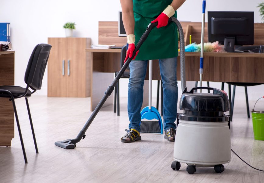 Young contractor cleaning the office